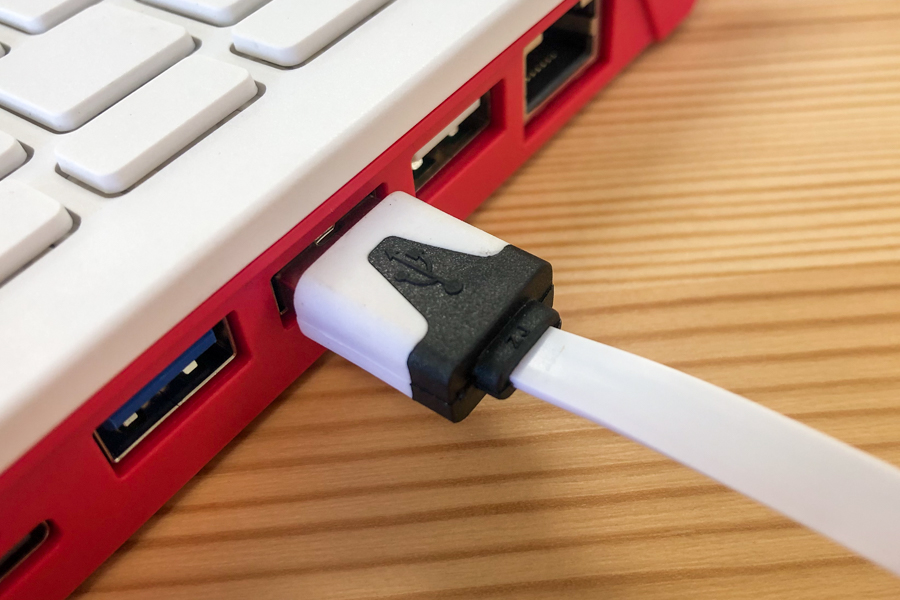 A photograph showing a USB cable plugged in to the port on a computer